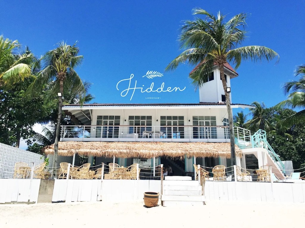 White beachfront Hidden Langkawi restobar with palm trees on Pantai Tengah