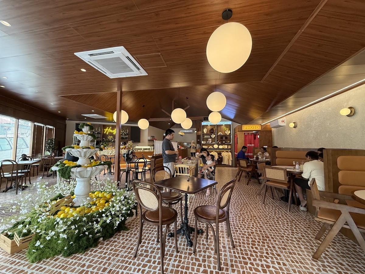 Howdy Café dining room with lemon fountain, globe lights and photobooth sign