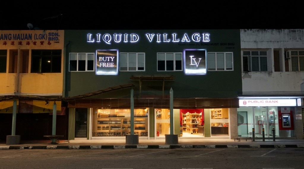 Liquid Village night facade with Duty Free and LV signs on Jalan Pandak Mayah 4