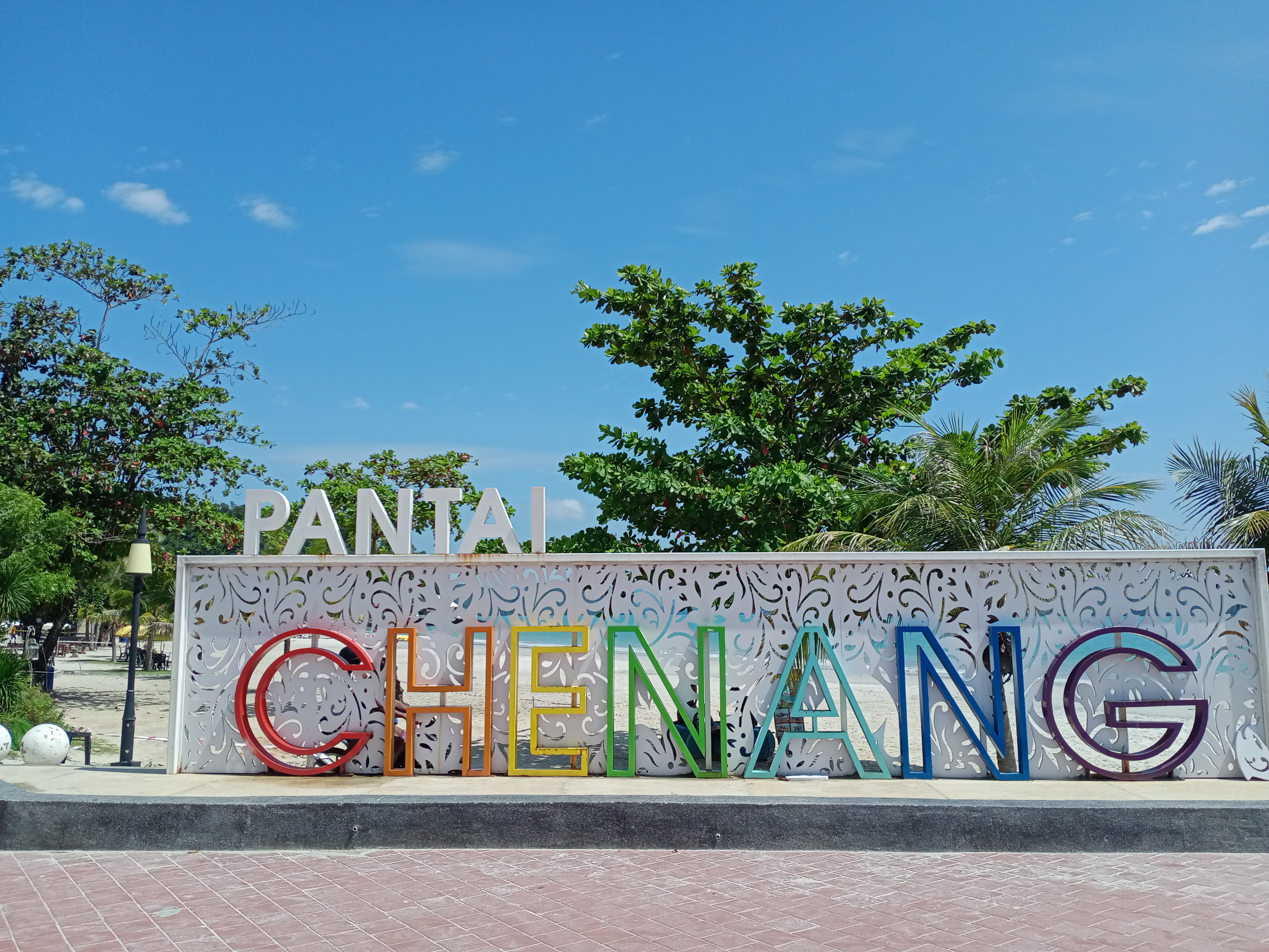 Wide sandy shoreline and calm water at Pantai Cenang Langkawi