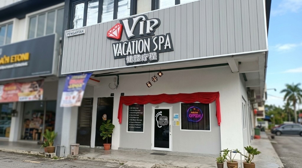 VIP Vacation Spa street shopfront with red valance and neon OPEN sign